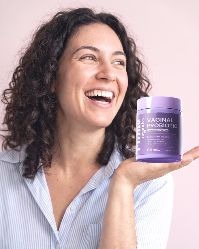 A smiling woman holding Prime Organics Vaginal Probiotic