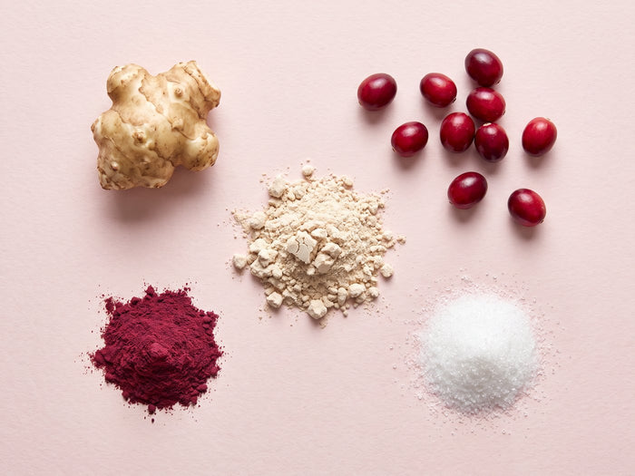 Cranberry, D-mannose, inulin and probiotic powder laid out
